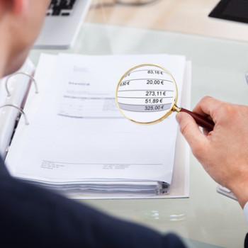 auditor-examining-invoice-with-magnifier-xs.jpg